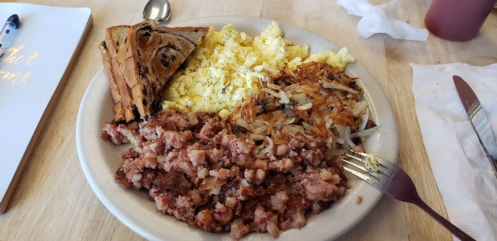 Scrambled Eggs Xtra Crispy Hash Brown Potatoes Corned Beef Hash and Raisin Toast